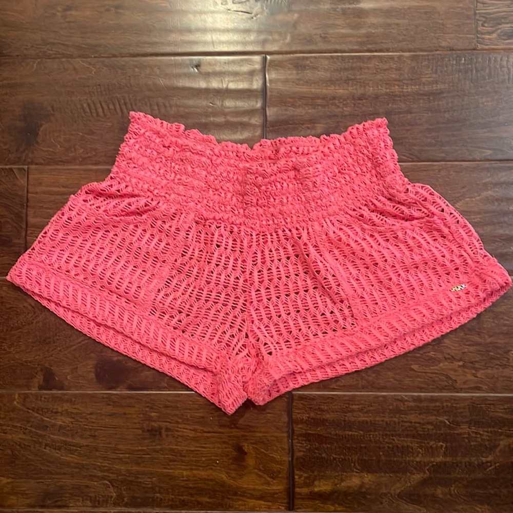 Pink knit shorts with elastic waist and see through knit material